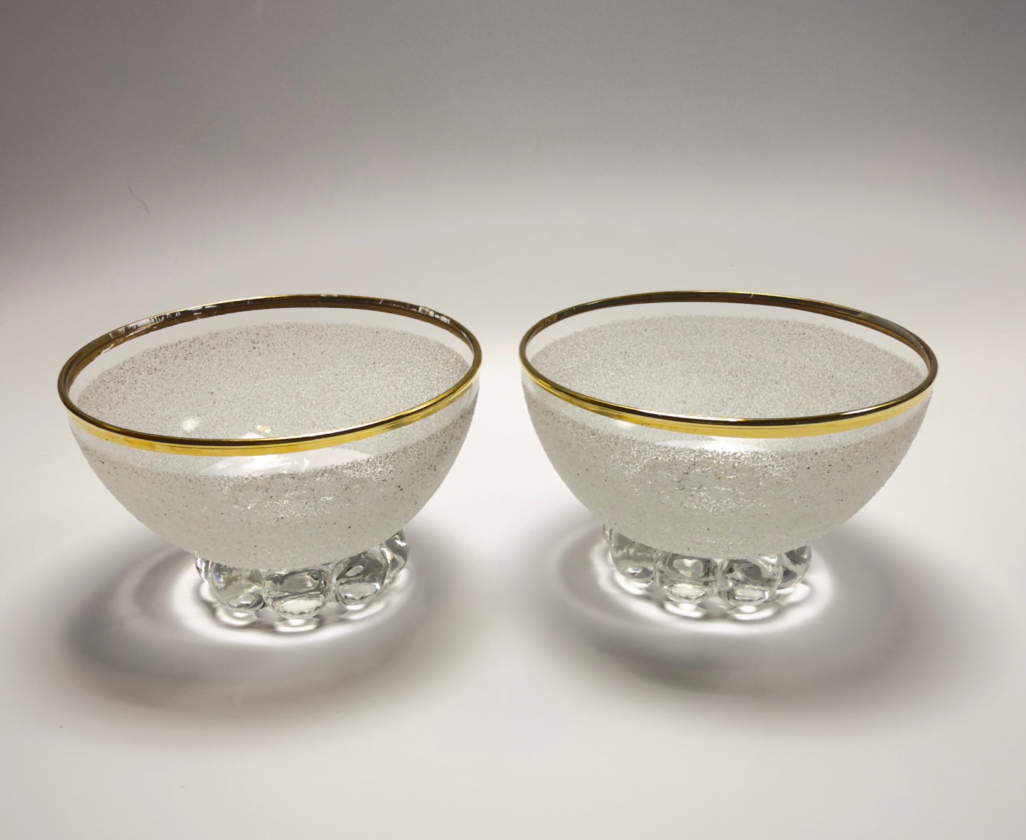 A set of vintage coupe glasses / dessert glasses with rough granulated glass surface and gold rim