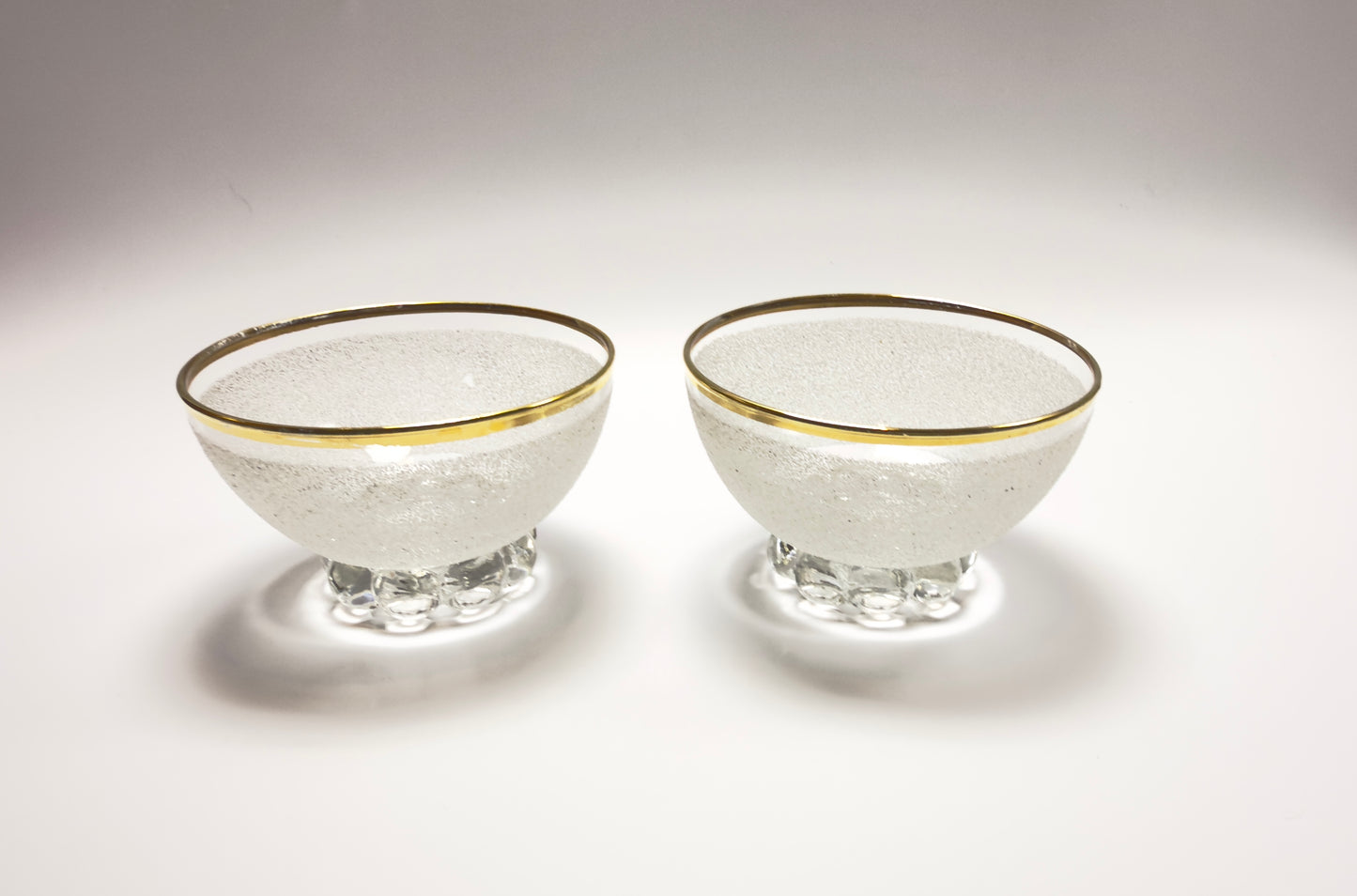 A set of vintage coupe glasses / dessert glasses with rough granulated glass surface and gold rim