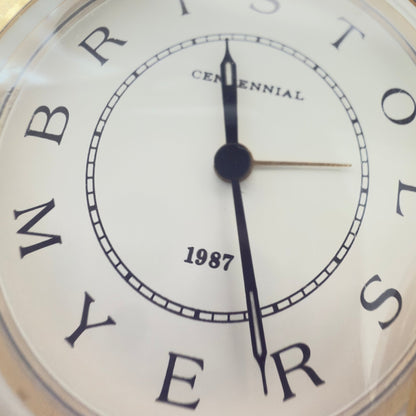 Bristol-Myers Centennial 1987 bordur/rejseur med alarm – firmamemorabilia - Frøken Lilly